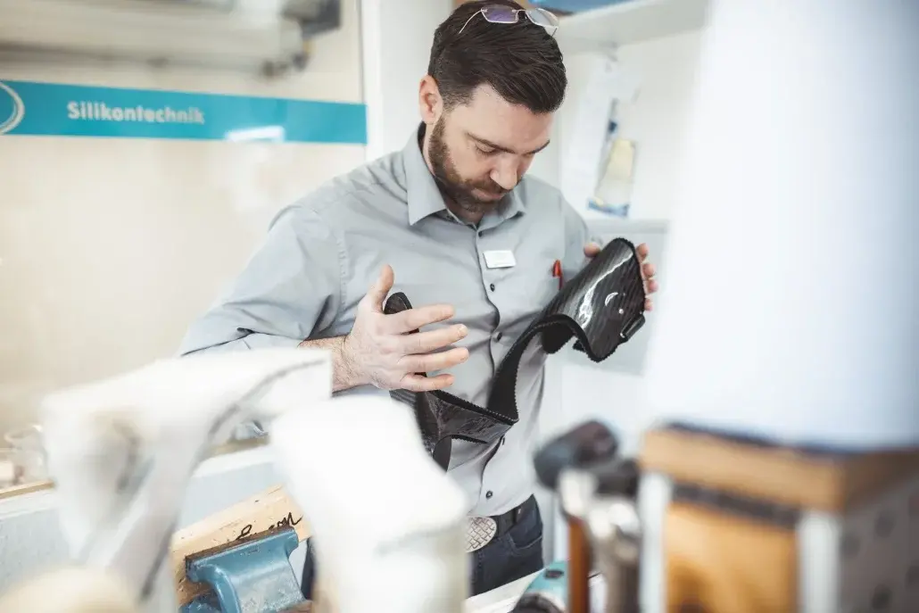 Ein Mann prüft in einer Orthopädietechnik-Werkstatt eine Prothese.